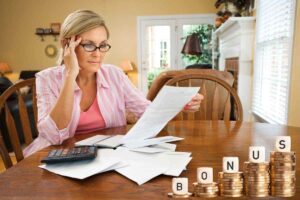 Donna alle prese con le bollette in attesa del bonus