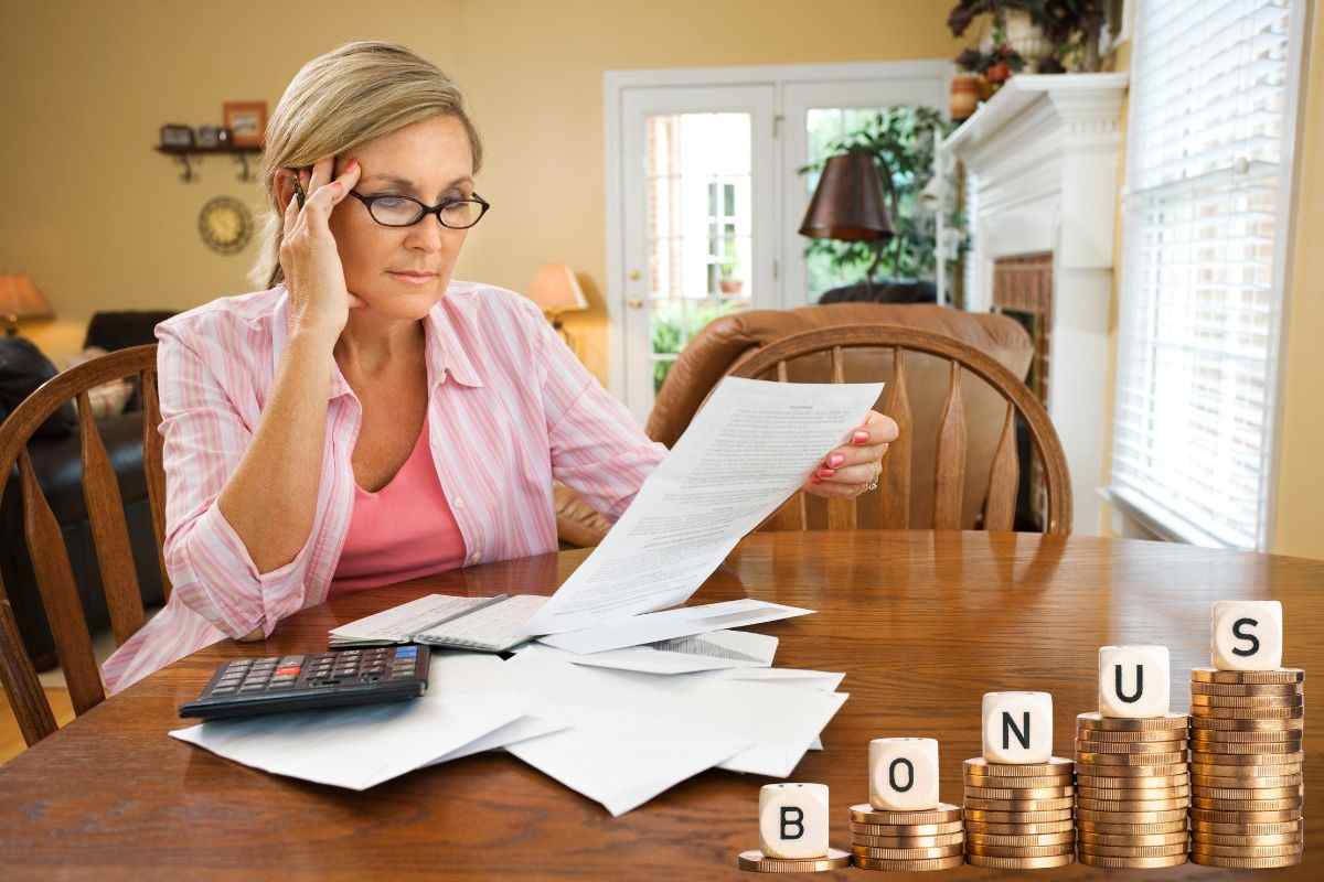 Donna alle prese con le bollette in attesa del bonus