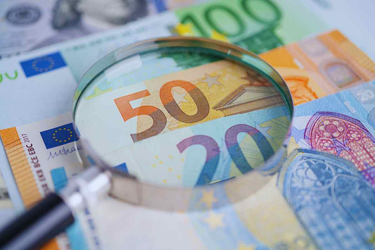 Lente d'ingrandimento poggiata su banconote