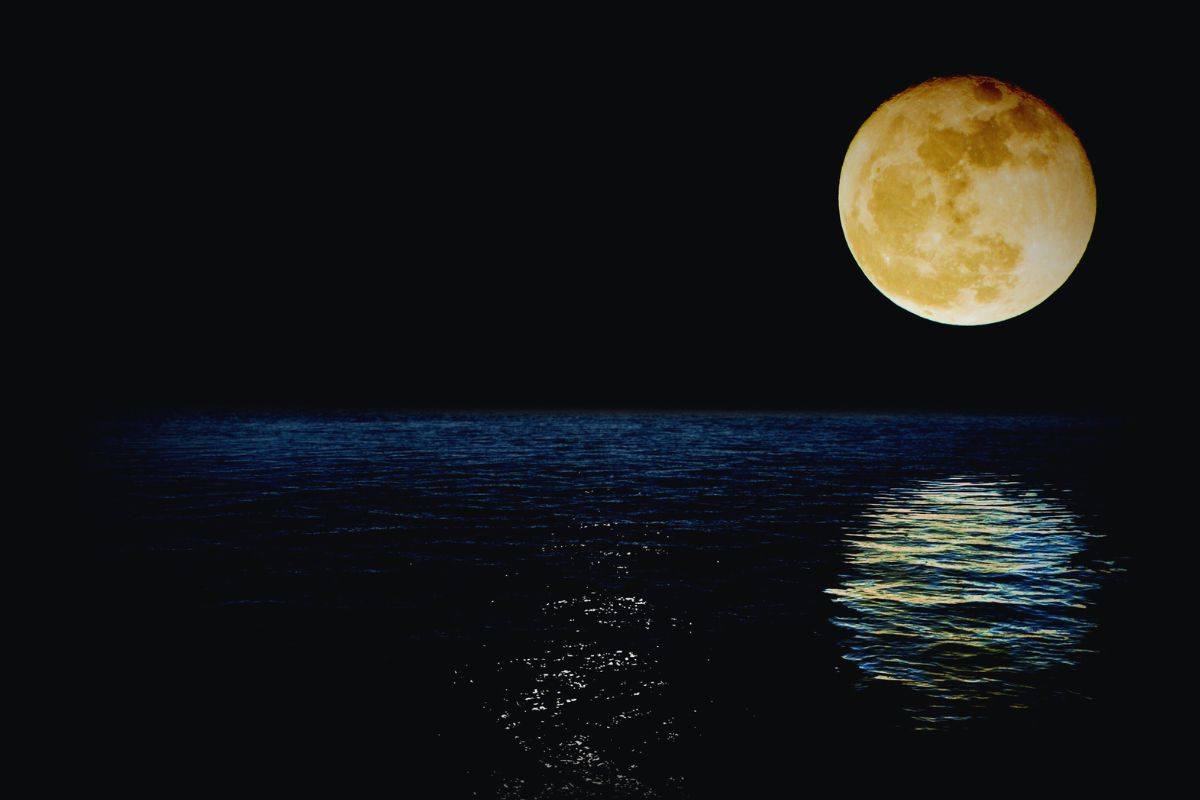 Superluna che brilla sopra uno specchio d'acqua placido